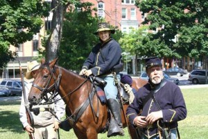 Capt. Robin Severy sits astride Parker as Tim Boutin, also of the 1st Vermont Cavalry Company K speaks to the audience during a demonstration on July 21, 2012 in Taylor Park during St. Albans Civil War Heritage Days.