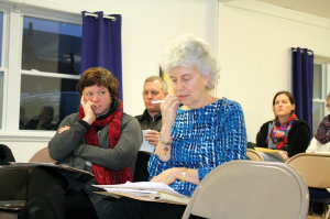 St. Albans Raid Commemoration Sponsorship Chair Denise Smith, listens as Cindy Rutkowski, who is in charge of administration, provides a report at a Wednesday meeting. Behind the women are raid volunteers Tom Hungerford and Michelle Saine.