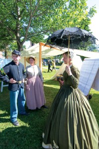Lynn Sawyer, of Cambridge, at right, representing the 18th Vermont speaks with Andrew Cassidy of Castleton, a member of the Civil War Medical Coalition, and Susan Brown, of Benson representing the 2nd Vermont during Civil War Heritage Days 2013, held last August. Sawyer has conducted a Civil War era clothing demonstration in St. Albans and will do so again Jan. 18 in preparation for the 2014 St. Albans Raid Ball, which invites participants to dress in 1860s garb. - GEORGE QUELLETTE photo