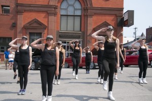Performers from the Electric Youth Dance Company preform in a ‘flash mob’ at the Kingman Street Klassic car show, July 19. The spontaneous dance number surprised attendants and brought awareness to the 150th anniversary of the St. Albans Raid, which will occur Sep. 18-21. (From left to right: Sydney Bergeron 14, Jayme Mead, 13 and Samuel Munson, 10.)