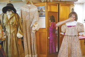 Cindy Leadbeater takes a young girl’s 1860’s dress off the hanger in her sewing room last month. Leadbeater estimates that by the time the St. Albans Raid 150th anniversary celebrations take place in late September, she’ll have made 16 period outfits. 
