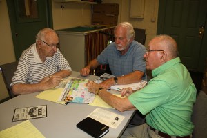 Bill Cioffi, left, and Warren Hamm, right, listen as Richard Cummings explains key point on his color-coded map of Taylor Park. The two co-chairs met with the raid façade and production chair Cummings in one of the dozens of sessions the many event volunteers have held to prepare for the St. Albans Raid 150th Anniversary Commemoration, Sept. 18-21.